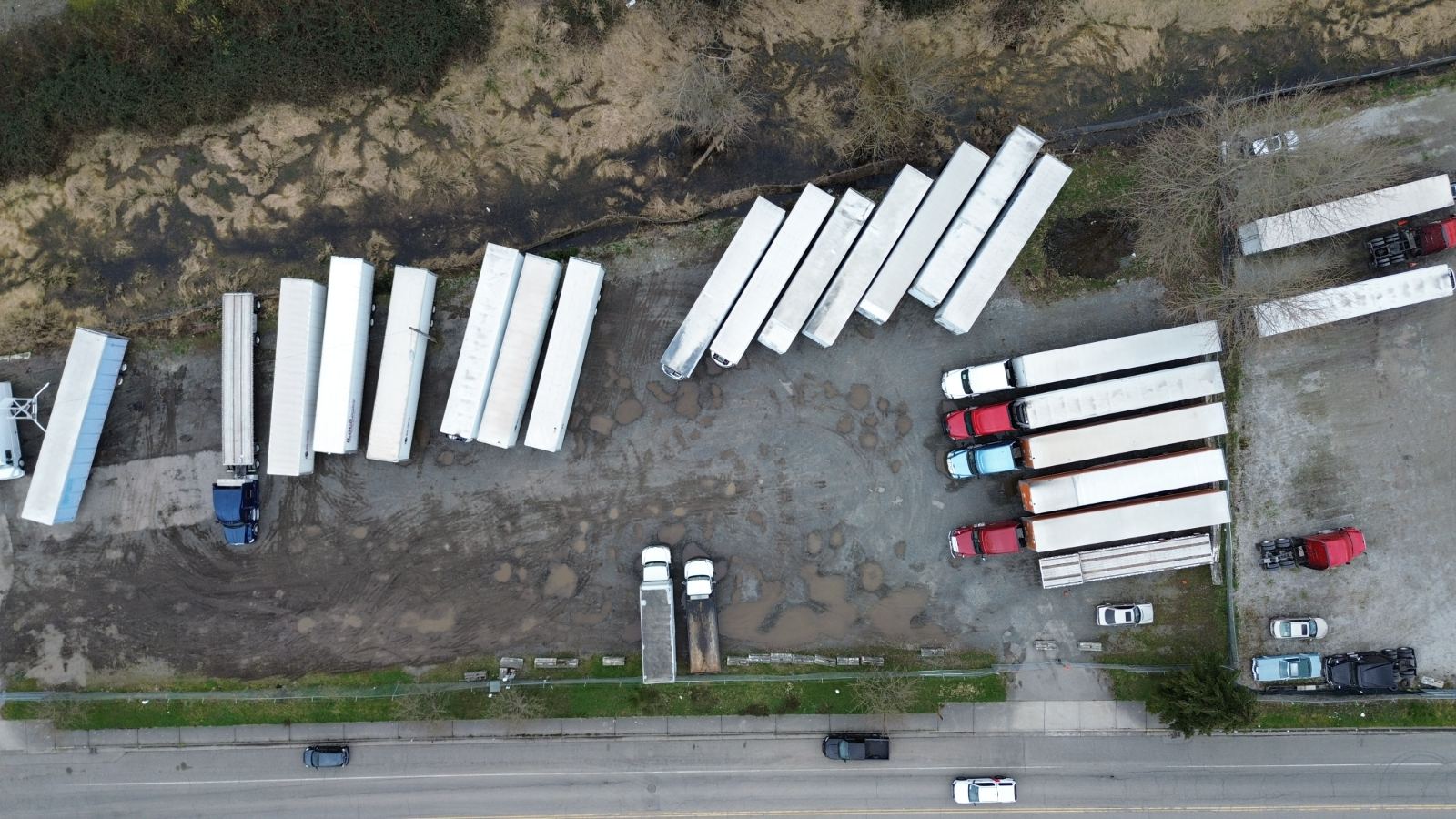 Drone view of the Pacific yard, a long row of trailers beside the road